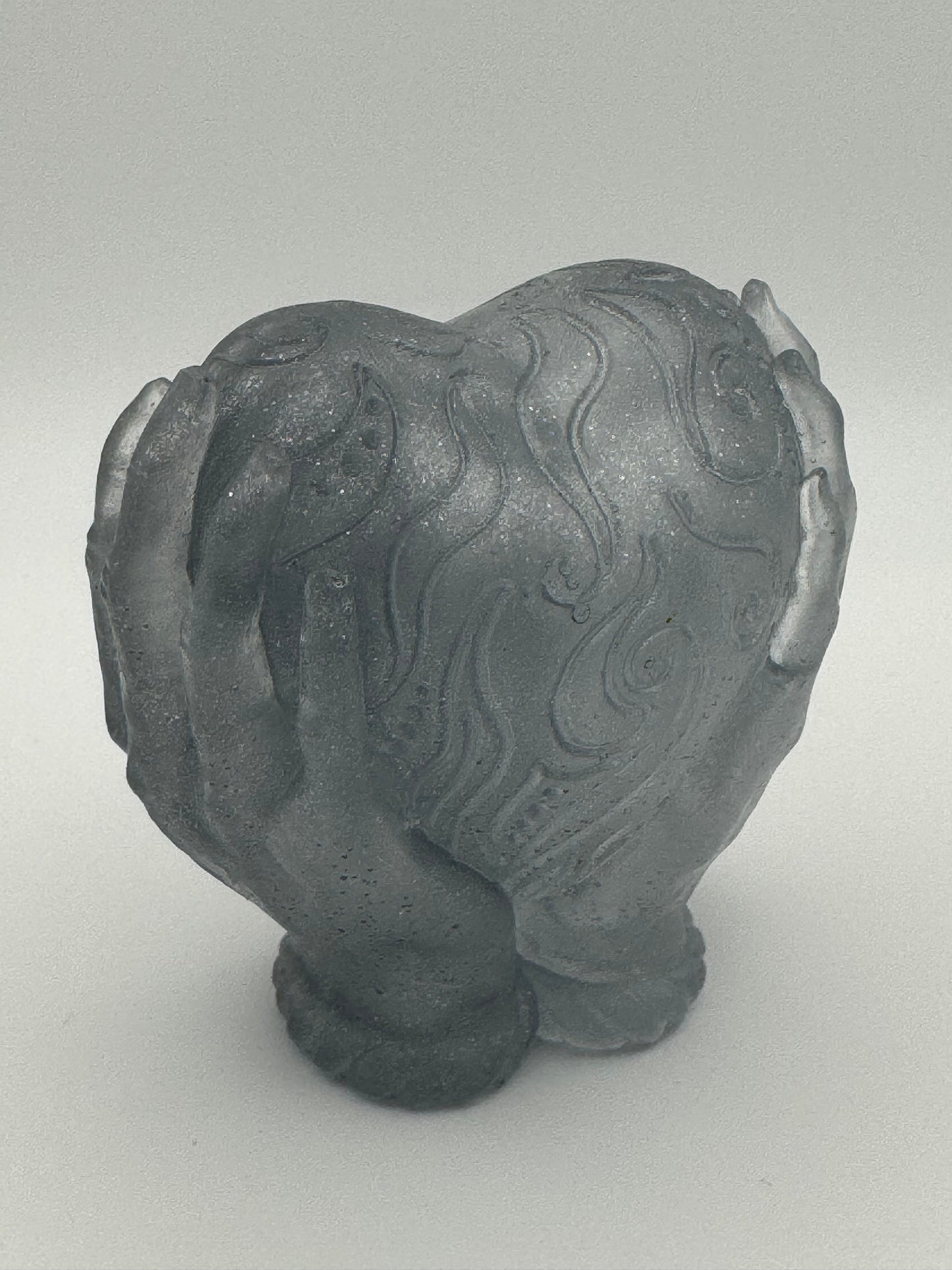 Silver resin ornament, hands holding heart