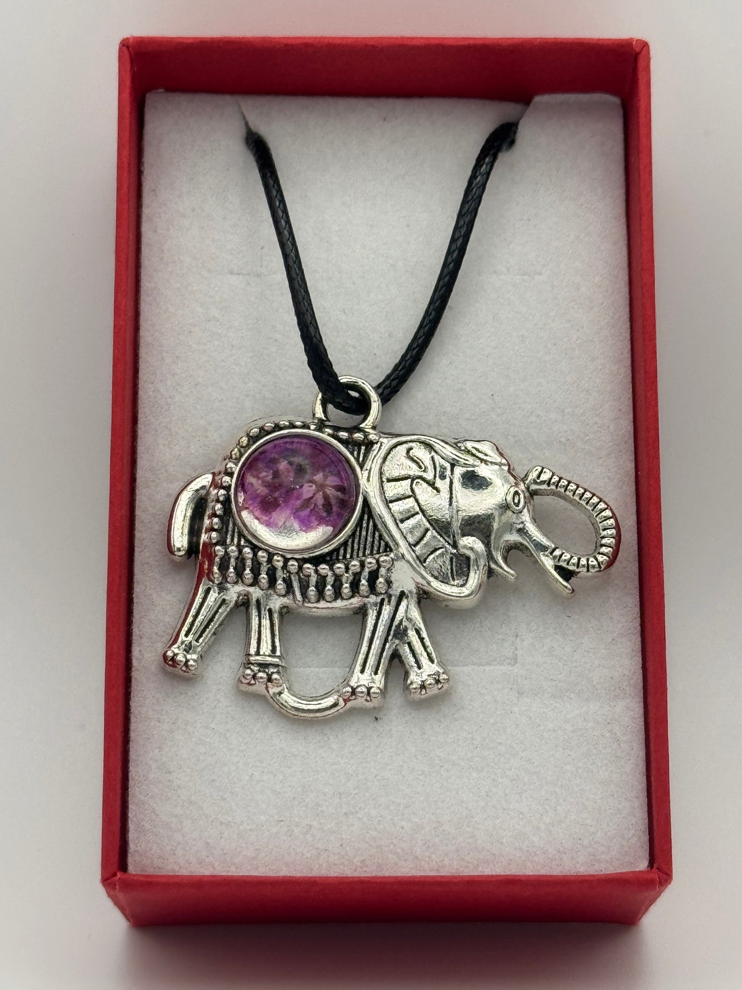 Necklace with metal elephant bezel and purple flower in resin, on a black waxed chain