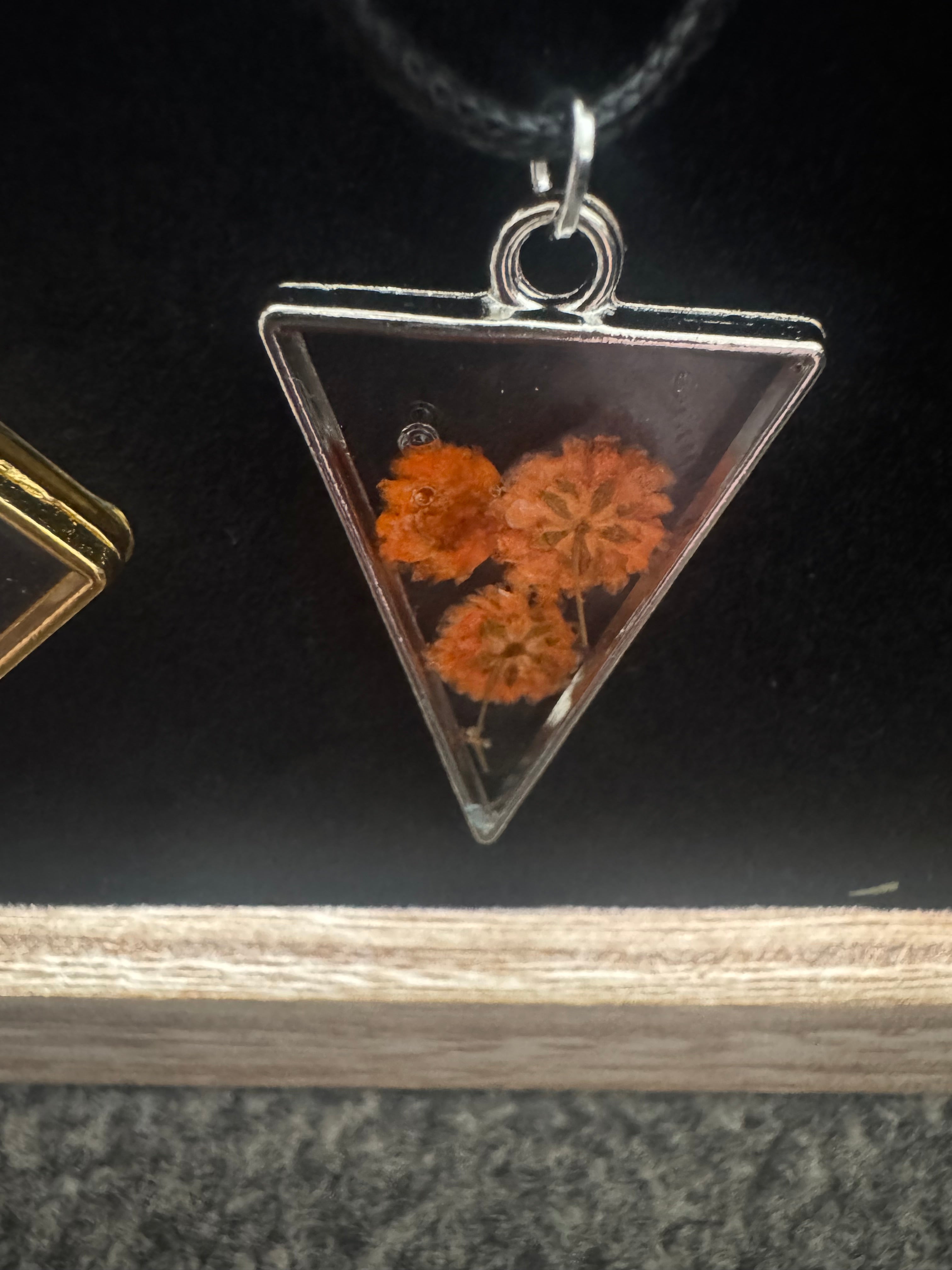 Necklace with metal bezel and flower inlay