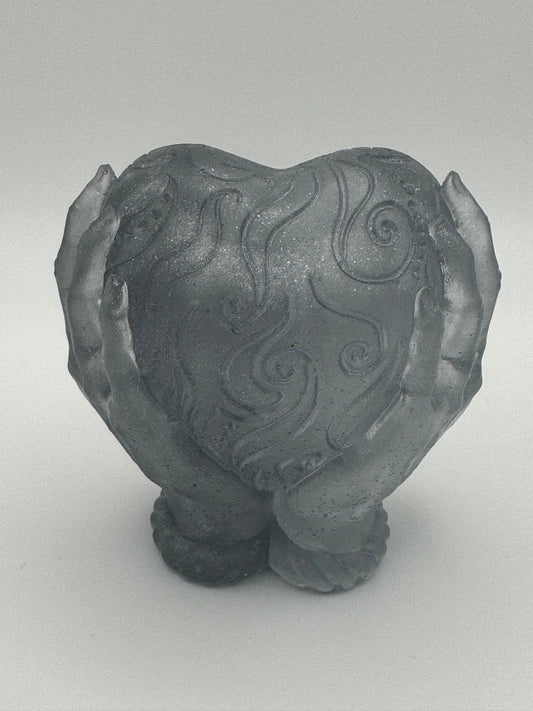 Silver resin ornament, hands holding heart