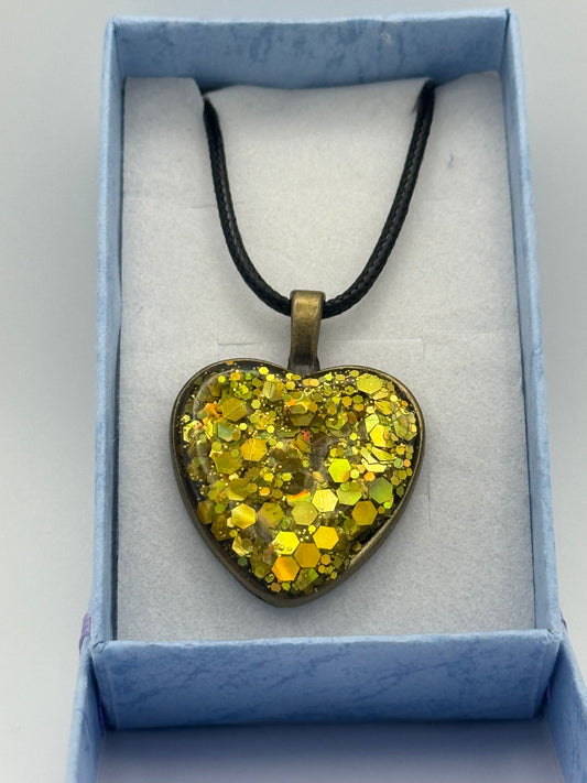 Gold resin heart with metal bezel necklace, with black waxed chain
