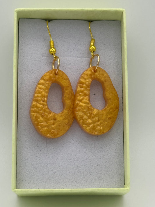 Gold coloured long resin earrings