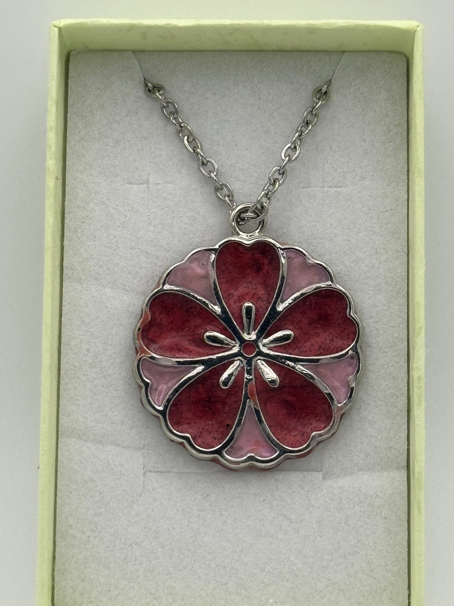 Red and pink resin in metal flower shaped bezel necklace, on a stainless steel chain