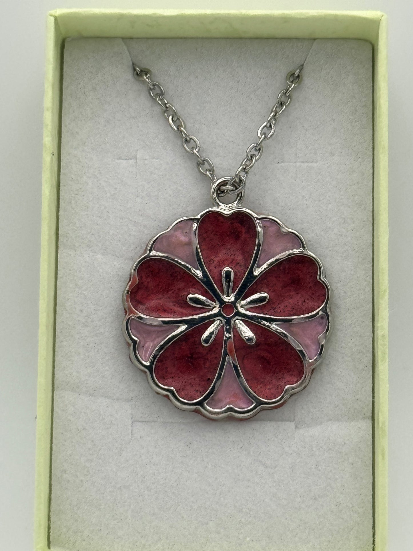 Red and pink resin in metal flower shaped bezel necklace, on a stainless steel chain