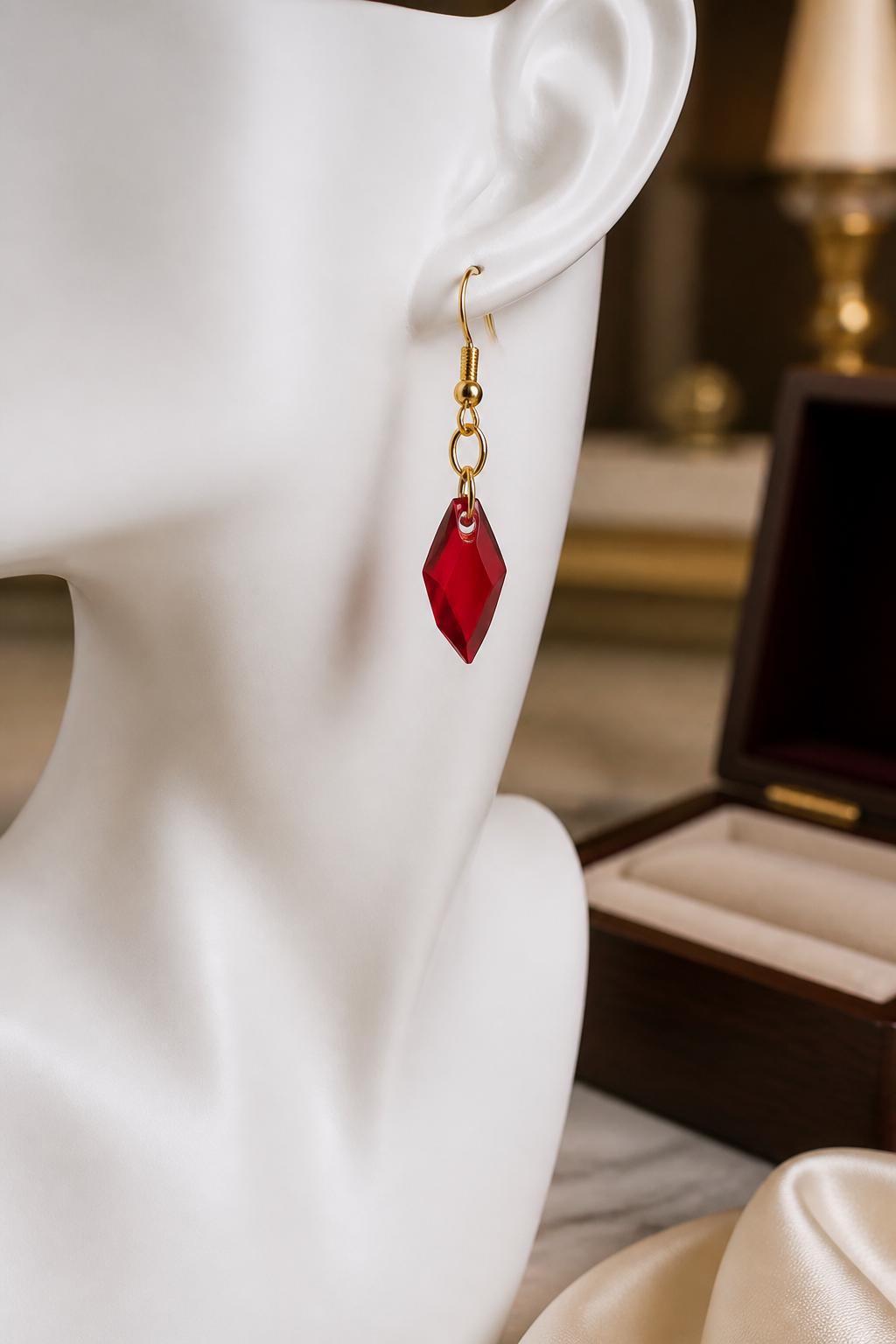 Red earrings on a white mannequin with a blurred background